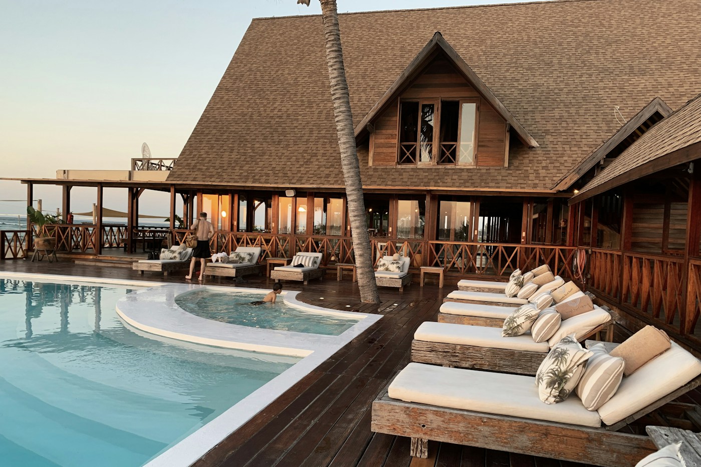 Sunlit resort with pool and palm trees